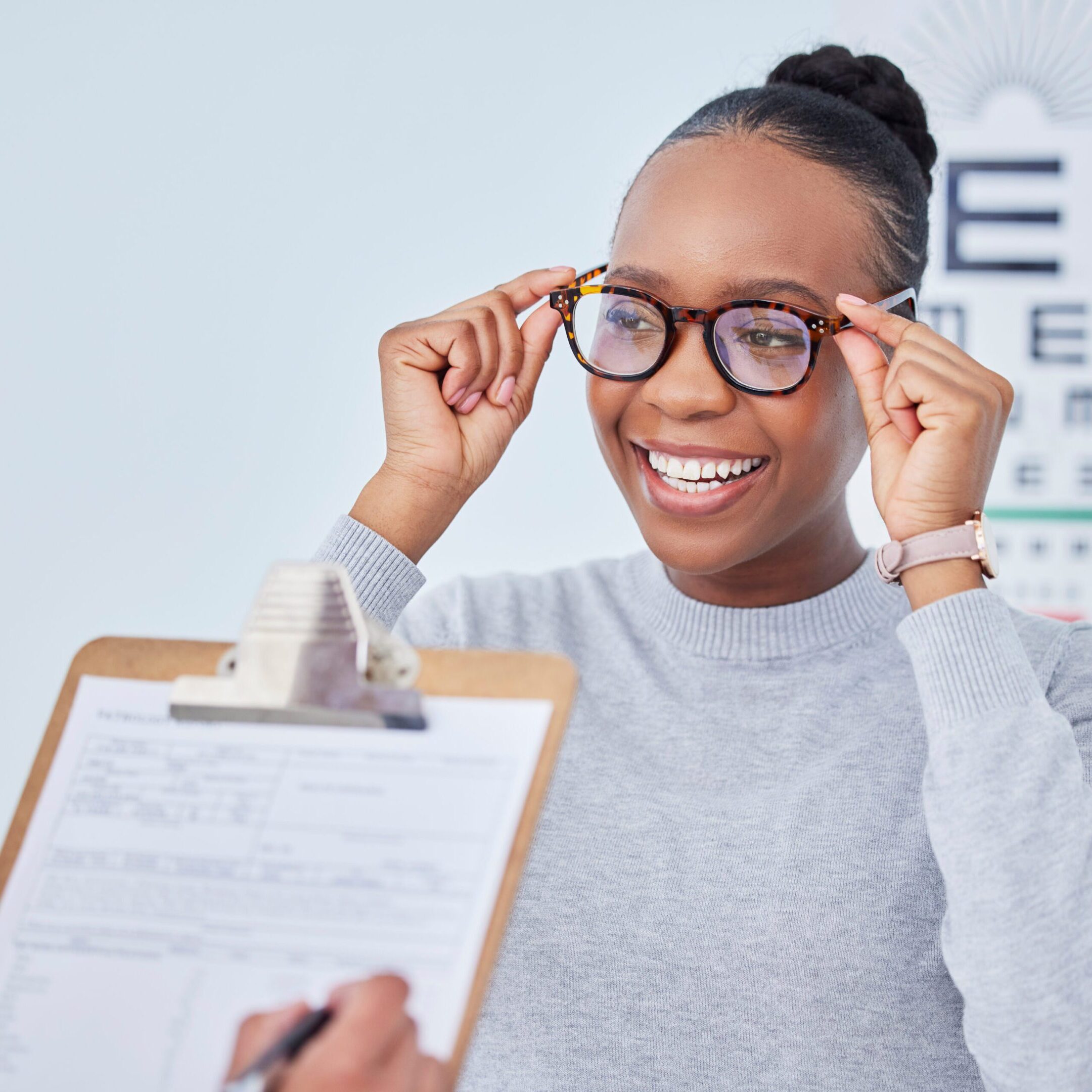 Black woman, glasses and vision, clipboard and optometrist with health insurance, prescription lens and frame. People at clinic, optometry and writing, checklist and info with eye care and documents