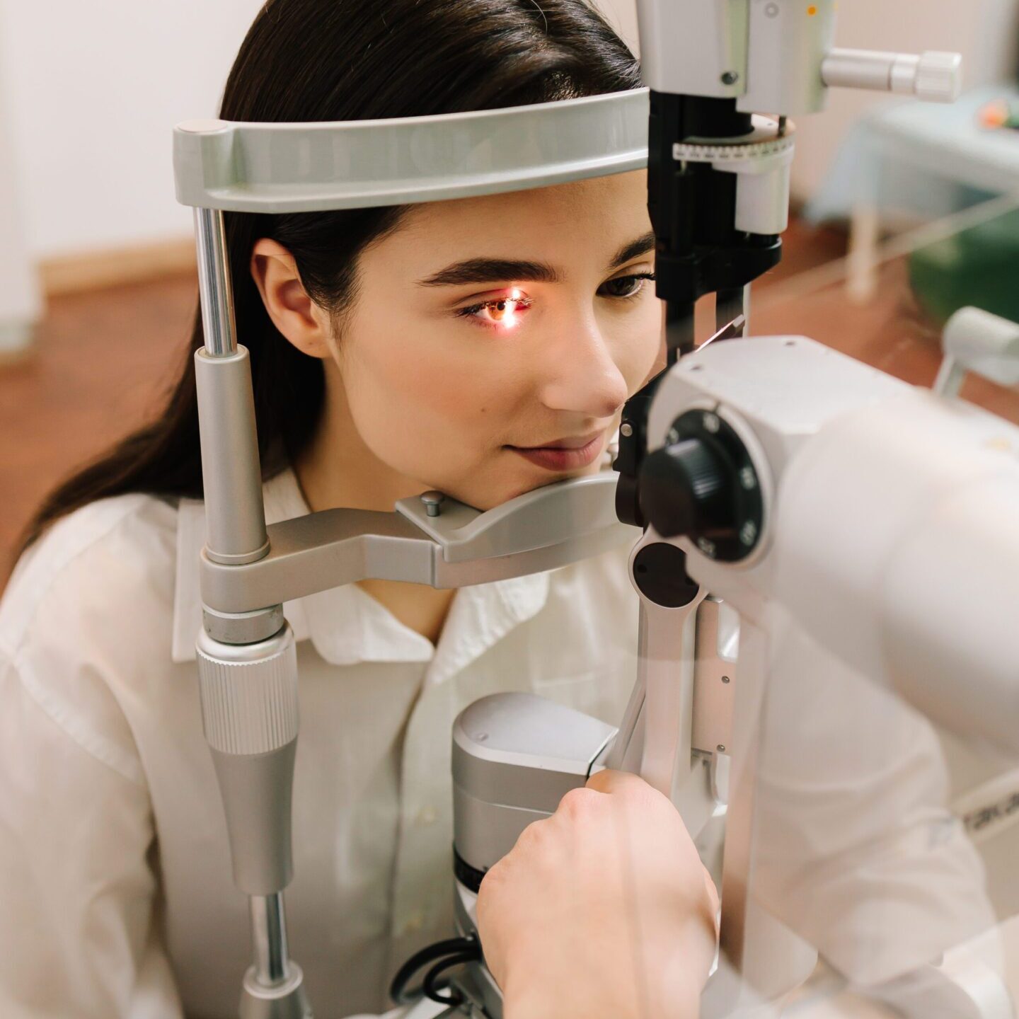 Ophthalmology procedure with slit lamp for eye and cornea checkup. Girl is visiting ophthalmologist for eyes examination.